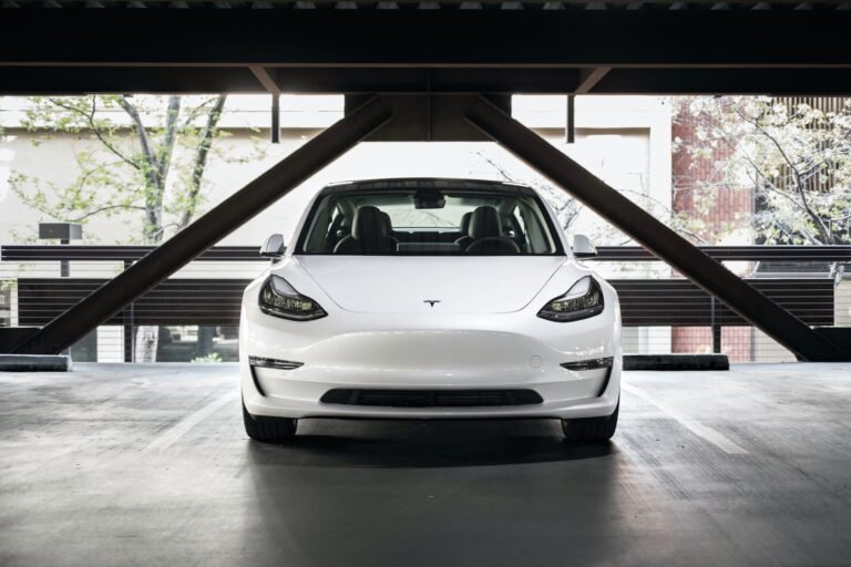White Tesla Model 3 from the 2017-2023 generation, front view, the car most Highland buyers are upgrading from